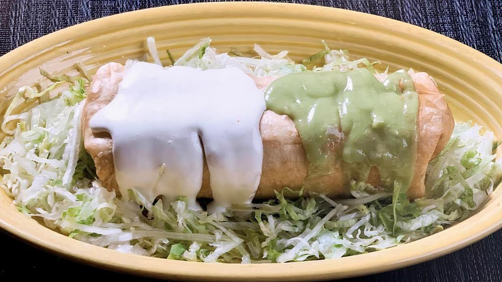 Chimichanga · Deep fried burrito with rice, beans, cheese, and choice of meat topped with sour cream and guacamole.