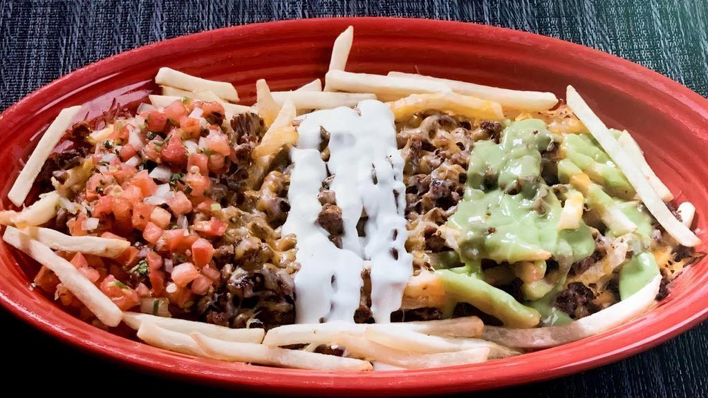 Iguana Fries · Fries topped with cheese, pico de gallo, sour cream, guacamole and your choice of meat.