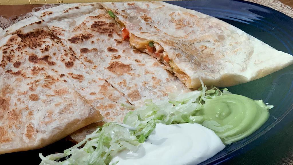 Fajita Quesadilla · Melted cheese, choice of meat, lettuce, tomatoes, grilled onions and bell peppers - served with sour cream and guacamole.
