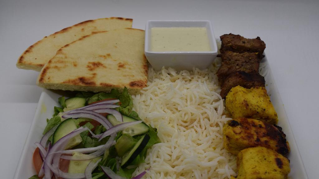 Mix Chicken And Steak Kabob · 3 piece chicken breast and 3 piece steak kabob over white basmati rice and 1 fresh cut pita and side salad and also includes white and chutney sauce on side.
