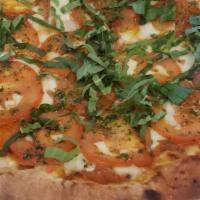 Margherita Pizza · Fresh tomatoes, basil leaves, and mozzarella cheese.
