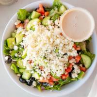 Greek Salad · Romaine, tomato, cucumber, feta, black olives, red onion, with Greek vinaigrette dressing.
