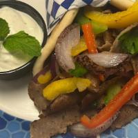 Western Gyros · Thinly sliced beef and lamb gyros cooked on a rotisserie with grilled bell peppers, onions, ...