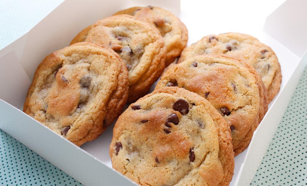 12 Chocolate Chip Cookies · Twelve of our signature gourmet chocolate chip cookies baked to perfection with a soft gooey center and filled with semi-sweet chocolate chips.
