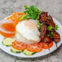 E4 - Grilled Pork Skewer & Fried Egg Rice Plate · Com thịt nướng Lu.

Rice entrées served with fried egg, lettuce, pickled carrots and daikon,...