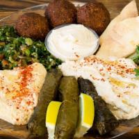 Veggie Plate · Served with 3 pieces of falafel drizzled with tahini, 3 pieces of stuffed grape leaves, humm...