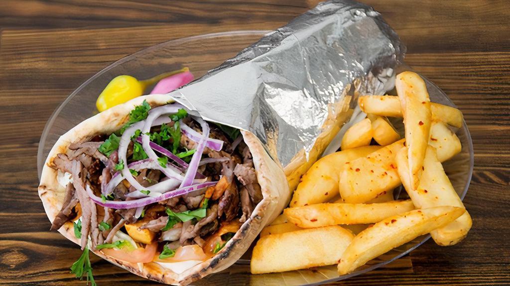 Beef Shawarma Combo · Beef wrapped with lettuce, tomato, onions drizzled with tahini sauce wrapped in Pita Bread.  Servied with Fries and soft drink of your choice