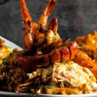 The Whole  Shebang · Shredded marinated chicken with deep-fried crab legs, Cajun flavored sautéed lobster tail, a...