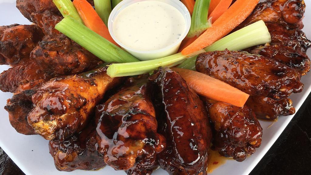 Smoked Wings · Authentic SMOKED WINGS, try them  today. Naked, buffalo, teriyaki, sweet chili, garlic parmesan, Mango Habanero or bbq sauce. Served with carrot and celery sticks and ranch dipping sauce.