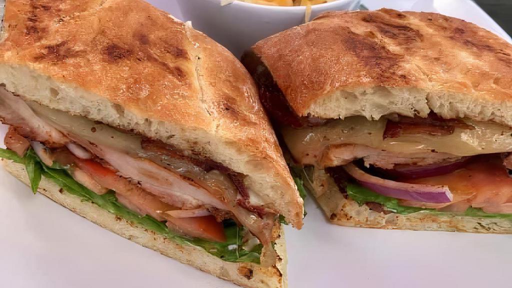 Club Chicken Sandwich · 7 ounce Smoked Chicken, lettuce, red onions, tomato, Smoked Bacon, avocado, mayo. Served on a Ciabatta Bread with one side.