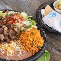 Carnitas  Michoacan · Served with rice, pinto or black beans, romaine lettuce with pepita dressing, guacamole and ...