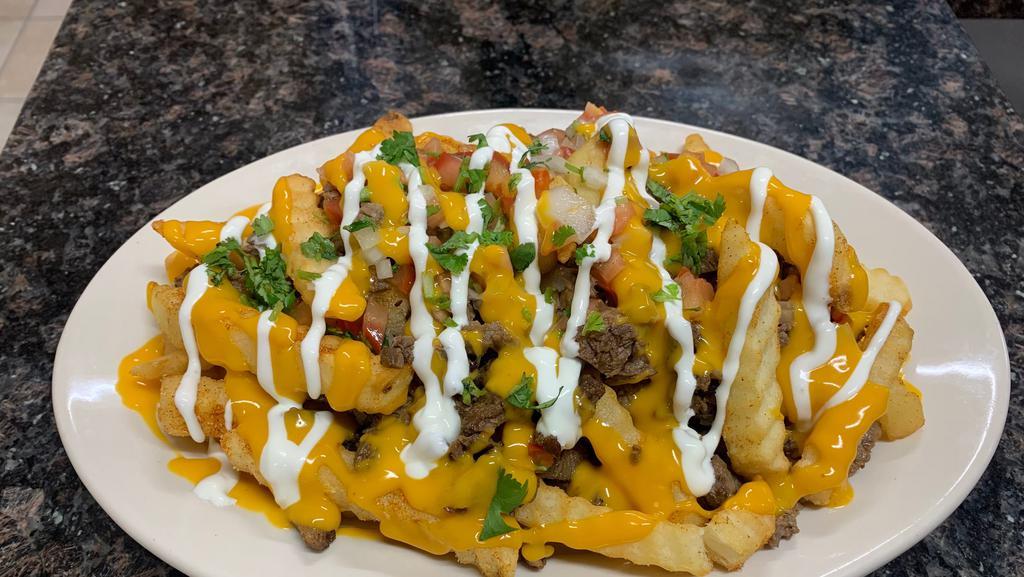 Asada Fries · French fries with nacho cheese, meat of your choice topped of with pico de gallo and sour cream