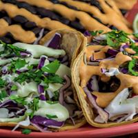 Taco Plate (V) · Two tacos with guacamole, cabbage, & Cilantro Lime Crema on corn tortillas with your choice ...