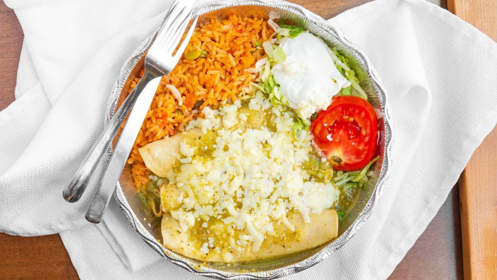 Enchiladas Verdes · Two pieces. Green tomatillo sauce topped with cheese, sour cream and avocado slices. Served with beans and rice.