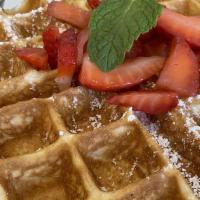 Homestyle Waffle · buttermilk waffle, warm butter, syrup, topped with powdered sugar and local strawberries.