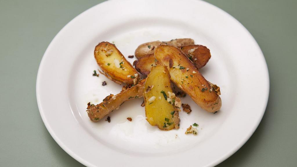 Patate · Pan fried potato with garlic and parsley.