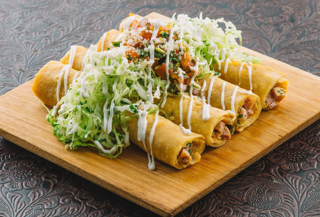 Rolled Chicken Taquitos · Mesquite chicken, poblano chillies and jalapeno jack cheese wrapped in 4 crispy corn tortillas. Served with cabbage slaw, avocado tomatillo sauce, pico and crema.