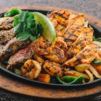 Fajitas Mixed Grill · Tender grilled steak, achiote marinated chicken breast and seasoned shrimp.