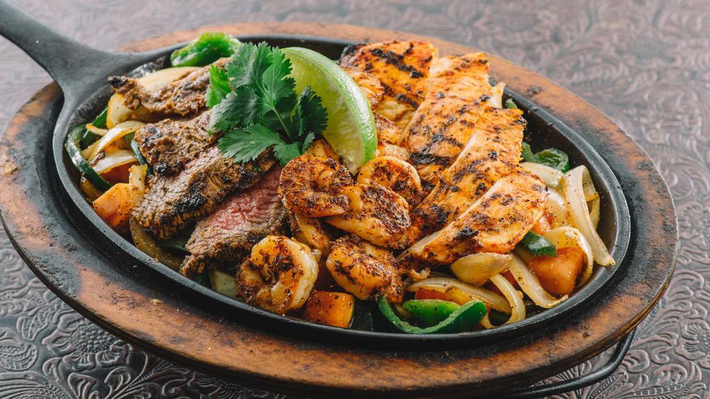 Fajitas Mixed Grill · Tender grilled steak, achiote marinated chicken breast and seasoned shrimp.