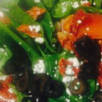 Spinach Salad - Medium · A bed of fresh spinach topped with olives, sun-dried tomatoes, cucumbers and feta cheese. He...
