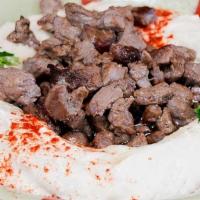 Hummus Kawarma · Hummus topped with beef filet and pine nuts. Served with 2 pcs of pita bread.