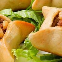 Sfiha · Baked spicy ground beef pies with onion, spices and pine nuts.