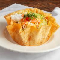 Tostada Salad · A large crispy flour tortilla bowl with chicken, pastor, carnitas or asada, beans, fresh ice...