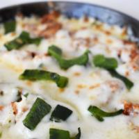 Queso Fundido · Homemade chorizo topped with melted mozzarela cheese served with corn or flour tortillas