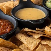 Trio Dips & Chips · crispy tortilla chips, house-made salsa, guacamole, queso