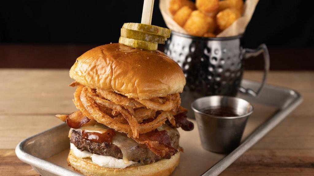 Bourbon Bbq Burger · Louie’s custom burger blend, cooked medium-well, applewood smoked bacon, cream cheese, Tillamook™ white cheddar, crispy onion strings, house-made bourbon bbq sauce