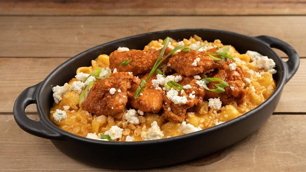 Buffalo Chicken Mac & Cheese · creamy four cheese and buffalo sauce, cheddar, mozzarella, and provolone cheeses, buffalo fried chicken, blue cheese crumbles, parmesan cheese, spiced Rice Krispies™, scallions