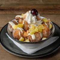 Tropical Loaded Donut Holes · sugar dusted, lime cream, diced pineapple, toasted coconut, whipped cream, amarena cherry