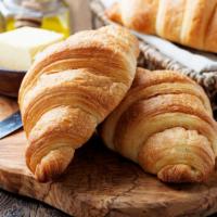 Croissant · Freshly baked croissant served with a side of butter and jam.