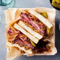 Pastrami Sandwich · Loads of delicious, spiced, and smoked pastrami on deli bread with your choice of ass ons.