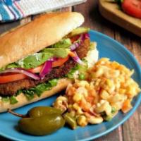 Tort Milanesa · Breaded meat, beans, tomato, lettuce, two types of cheese and grilled onions.