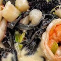 Linguine Nere · Black linguine pasta with bay scallops, buy shrimp, leeks in cream sauce and caviar.