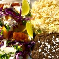 Beer Battered Fish Taco Plate  · includes black refried beans, delicious jazmine rice and 2 premium beer battered fish tacos;...