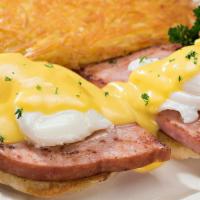 Eggs Benedict · Smoked ham and poached eggs on an English muffin topped with creamy hollandaise sauce and se...