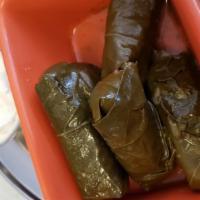 Veggie Dolmades · Grape leaves stuffed with rice and served with tzatziki.