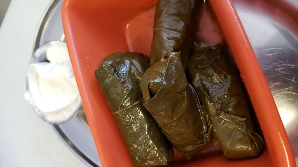 Veggie Dolmades · Grape leaves stuffed with rice and served with tzatziki.