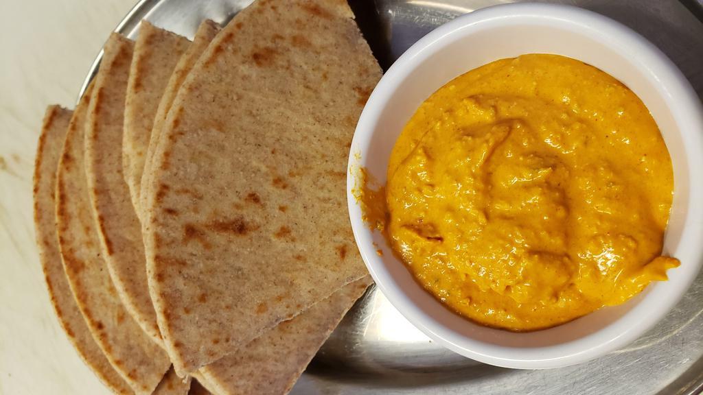 Fire Roasted Red Pepper Dip With Pita · Tirokafteri. Greek dip of blended cheese, roasted red and serrano peppers, olive oil, and garlic. Served with warm white or wheat pita.