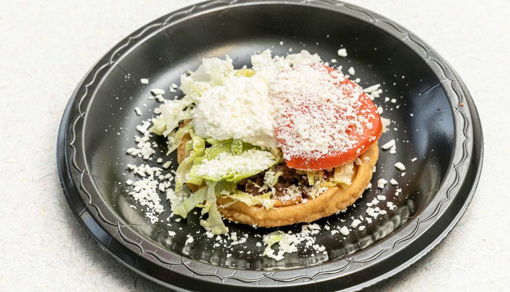 Beans Sope · Served with beans, lettuce, sour cream, cheese, and tomato.