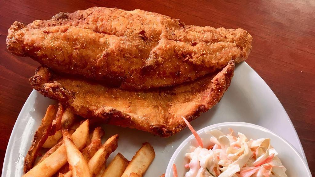 Fried Catfish · Two farm-raised catfish fillets, coated in cornmeal and fried with cajun spices, served with creamy coleslaw and french fries.