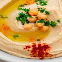 Hummus · Garbanzo beans, fresh garlic and tahini blended together and topped with olive oil and papri...