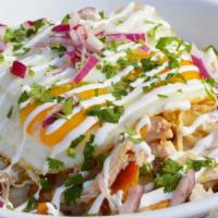 Chilaquiles Bowl · Corn tortilla chips sauteed with red or green sauce.  Topped with Jack cheese, two eggs, red...