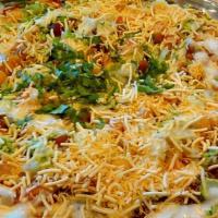 Chaat Puri (Papdi Chat) · Flat flour chips topped with potatoes,  ragda, green & sweet chutney, yogurt, sev and spices...