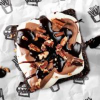 Mocha Mud Pie Brownie · Rich fudge brownie topped with decadent whipped cream, rich mocha frosting, toasty pecans & ...