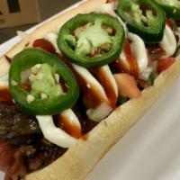 A. Dog · 100% Angus beef dog, topped with caramelized onions, pico de gallo, bacon, jalapeños, Tapati...