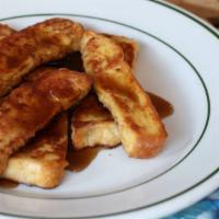 French Toast Sticks · Eight sticks of thick, egg-washed cinnamon bread served with maple syrup.