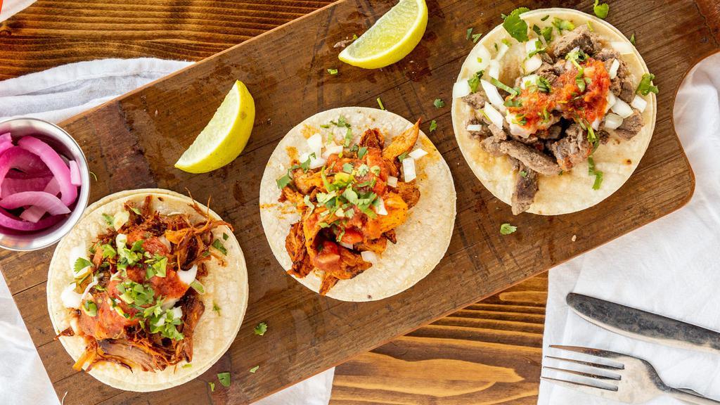 Taco Trio · With your choice of meat, asada, shredded chicken, pollo asado, ground beef, al pastor & carnitas